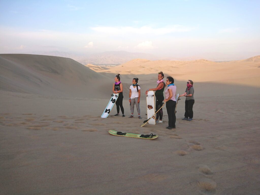 Waiting for the next sandboarder to run down the dune. The tourist route Huacachina Oasis, Peru.